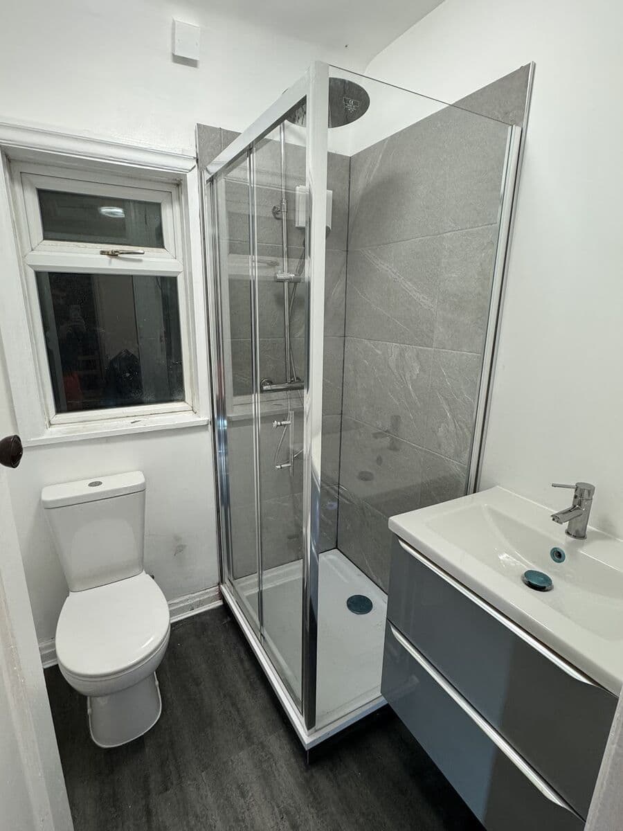 Modern shower room renovation with glass enclosure, grey porcelain tiles, and vanity unit - Nottingham bathroom project