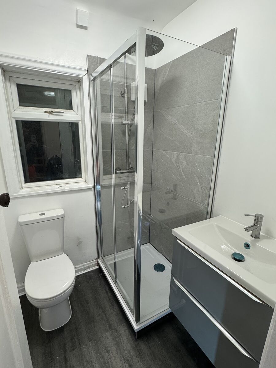 Modern shower room renovation with glass enclosure, grey porcelain tiles, and vanity unit - Nottingham bathroom project
