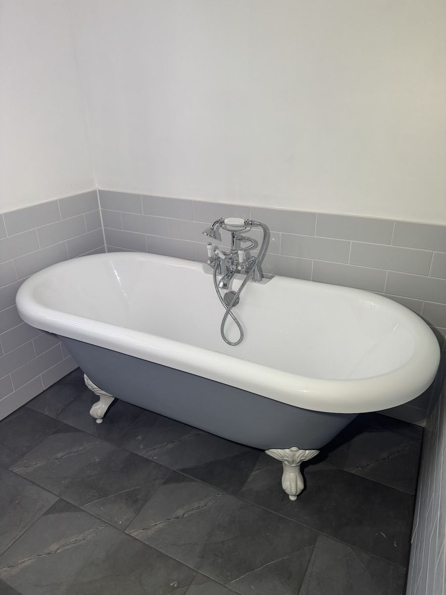Freestanding clawfoot bath installation with grey metro tiles and slate-effect flooring